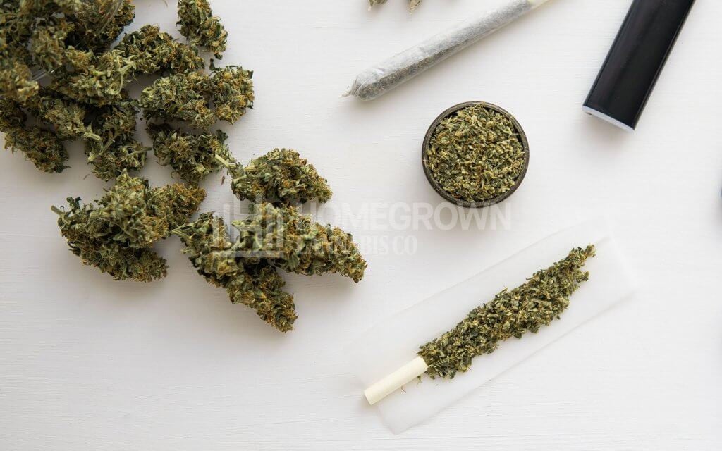 Weed buds, joint and grinder